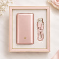 Blush pink CozyCrown rechargeable power bank with USB cable